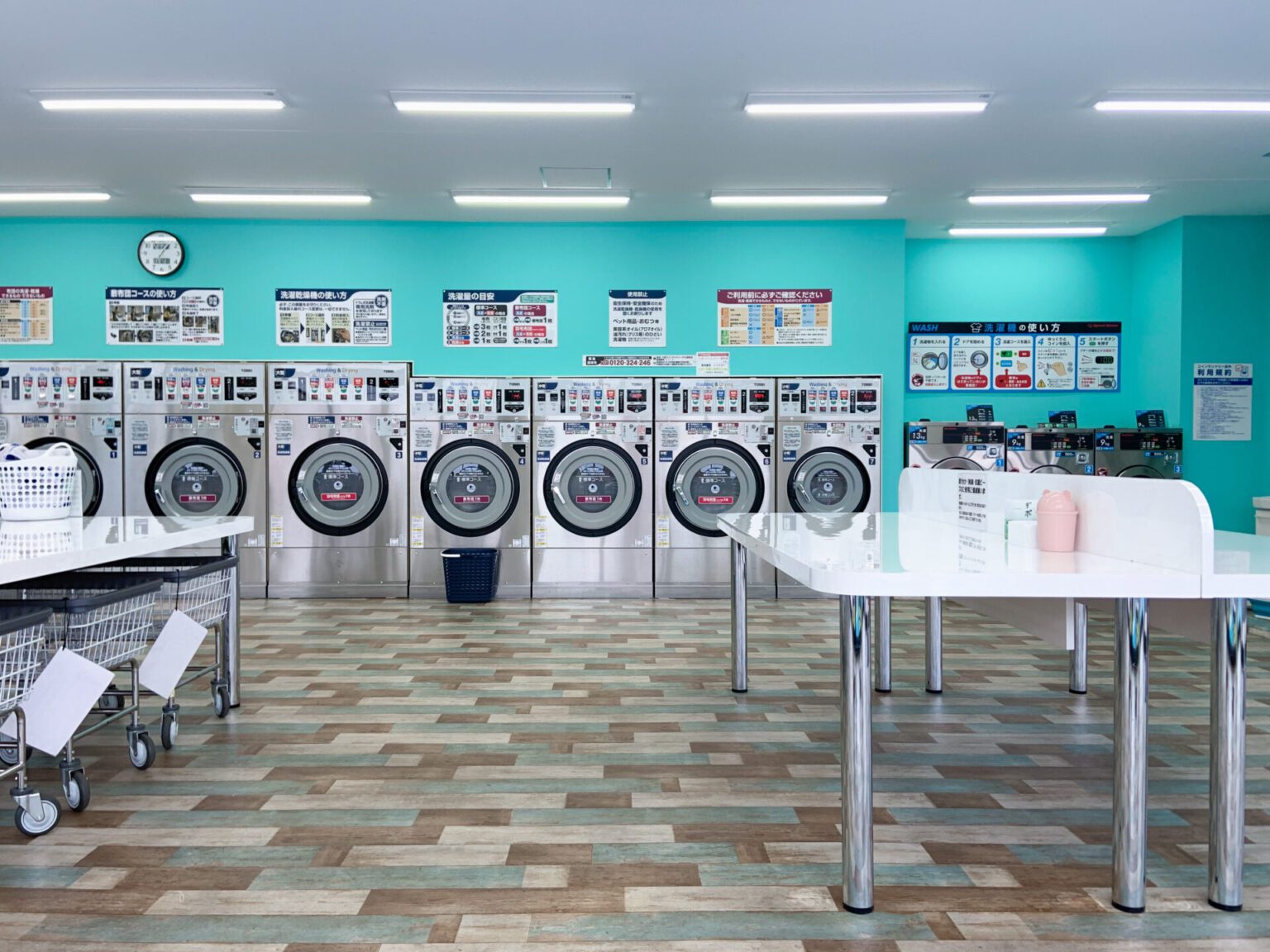 Inside the japanese laundromat with teal paint and shiny machines. how to use the laundromat in japan